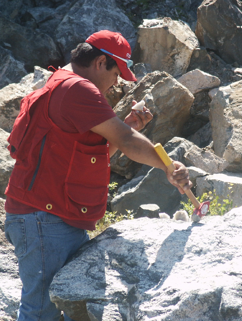 Gordon Blackned, Cree prospector, hammering rock samples