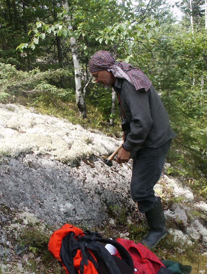 Frederick Whiskeychan, Cree prospector, hammering rock